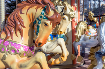 Fototapeta na wymiar Horses on the old children's circular carousel.
