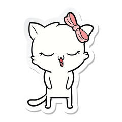 sticker of a cartoon cat with bow on head