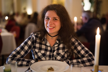Love, relationship and date concept - Happy young woman over candlelight during romantic dinner at restaurant