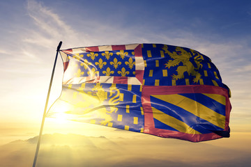 Bourgogne-Franche-Comte of France flag waving on the top sunrise mist fog