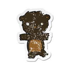 retro distressed sticker of a cartoon black bear cub
