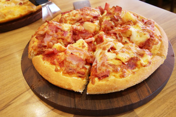 pizza served at restaurant on handled wooden board