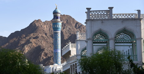 Emporragendes blaues Minarett einer Moschee vor einer Berglandschaft