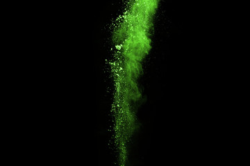 The movement of abstract dust explosion frozen green on black background. Stop the movement of powdered green on black background. Explosive powder green on black background.