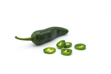 green peperonis on a white background