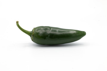 green peperonis on a white background