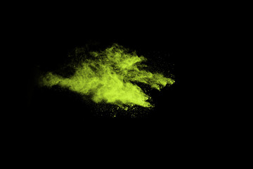 The movement of abstract dust explosion frozen green on black background. Stop the movement of powdered green on black background. Explosive powder green on black background.