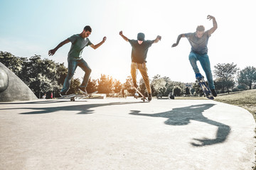 Skaters jumping with skateboard in city skate park - Main focus on left guy © DisobeyArt