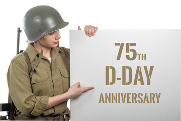 young woman dressed in us  wwii military uniform with helmet showing signboard with d-day...