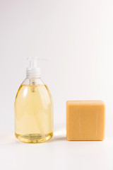 liquid soap and piece of  soap isolated on a white background