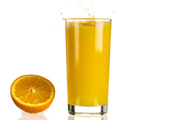 Pouring orange juice into a transparent glass on a white background