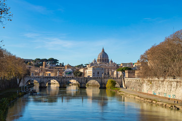 Rome skyline with Vatican St Peter Basilica and St Angelo Bridge crossing Tiber River in the city center of Rome Italy. It is historic landmark of the Ancient Rome and travel destination.