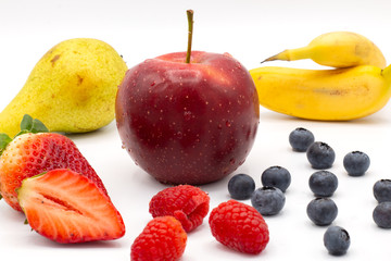 fruits and berries on plate isolated on white