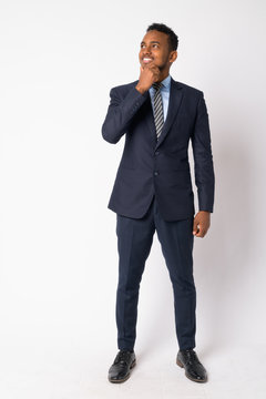 Full Body Shot Of Happy Young African Businessman In Suit Thinking