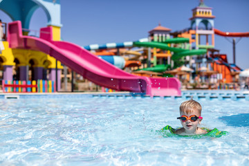 little boy in swimming pool of aquapark