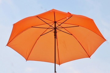 Orange umbrellas floating on the air, isolate on the background, sunset sky.