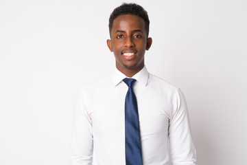 Happy young African businessman with Afro hair smiling