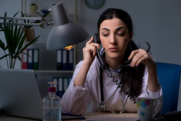 Young female doctor working at night shift 