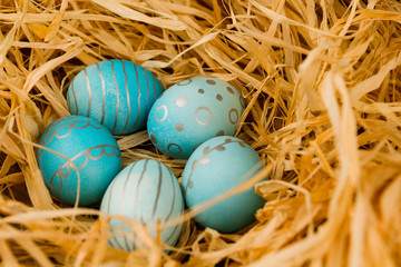 Fototapeta na wymiar Easter eggs lie in the hay. Holiday concept