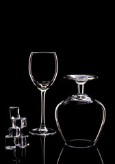 Glasses for wine and brandy with ice on a black background.