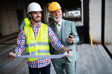 Construction engineer with foreman worker checking construction site