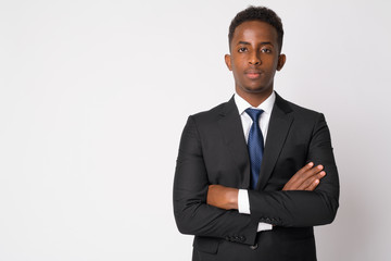 Portrait of young African businessman in suit with arms crossed