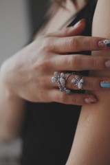 beautiful ring with butterflies on hand with manicure