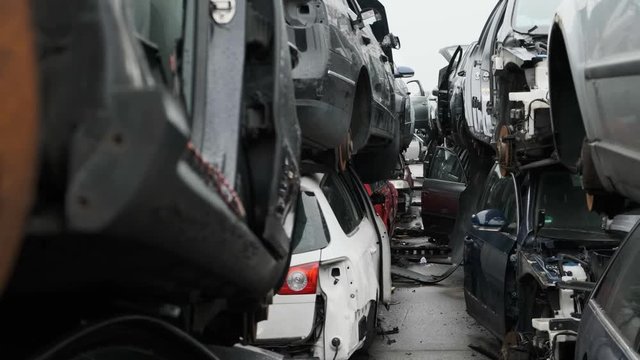 Scrapyard scene, walking through a tunnel of destroyed cars.