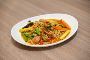 spaghetti with sausage in white plate- Italian food