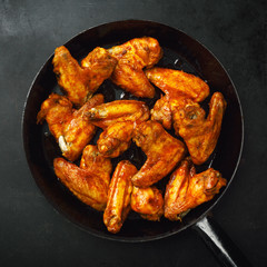 Chicken wings grilled in sauce on pan