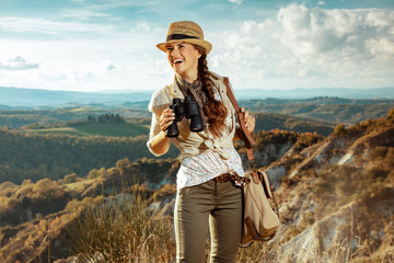 solo tourist woman with binoculars looking into the distance