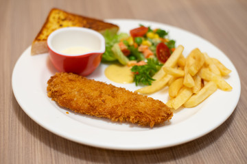 Fried salmon steak and appetizer on the table