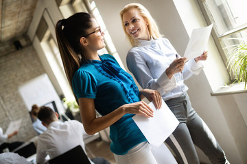 Naklejka premium Business, technology and people concept - creative team or designers working in office