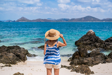 Young woman relaxing and enjoying at the tropical beach, Summer vacation and travel concept