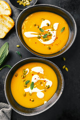 Pumpkin creamy soup served in bowls