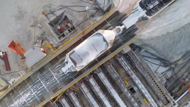 Aerial cenital drone shot of a large truck unloading salt in the salt flats by solar evaporation in Guerrero Negro, Ojo de Liebre lagoon, Biosphere Reserve of El Vizcaino, Baja California Sur.