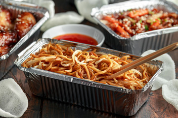 Chinese takeaway food. egg noodles with bean sprouts, chilli dip and prawn crackers