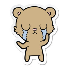 sticker of a crying cartoon bear
