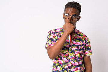 Portrait of young African tourist man adjusting eyeglasses