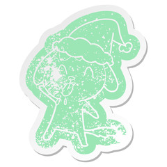 cute cartoon distressed sticker of a dog wearing santa hat