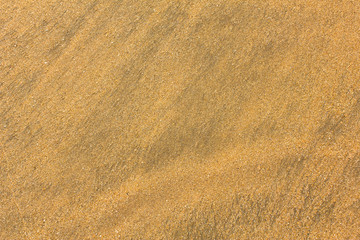 Fototapeta na wymiar yellow sand with black stripes close-up. natural surface texture