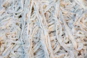 Fabric scraps, old clothing and textiles are cut into strips waiting for recycle.