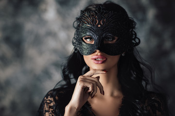 Fototapeta portrait of sexy beautiful woman in lace black erotic lingerie and carnival mask on dark background obraz