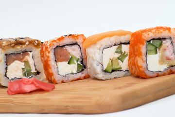 set of sushi rolls on wooden Board on white background.
