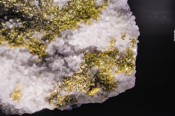 Background or texture from a stone in a section with pink and gold crystals. Natural and solid material. Minerals.