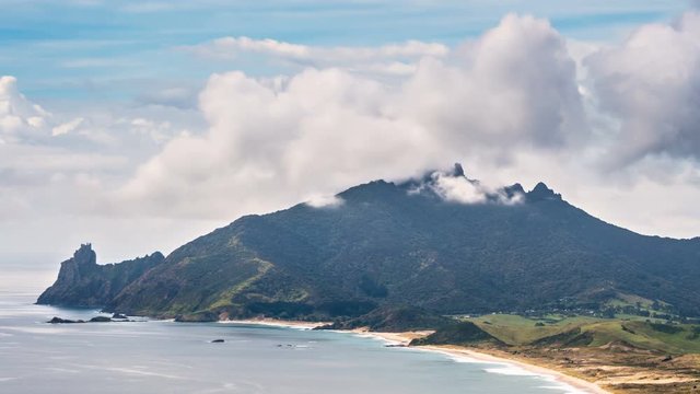 Clouds moving fast over ocean beach mountains Time lapse