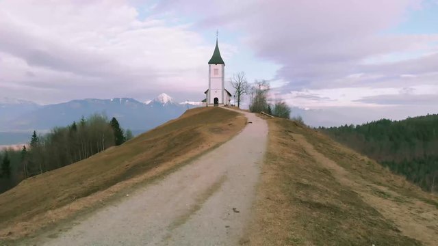 Road to the church on the meadow hill. Going to church with a beautiful view in the backgorund.
