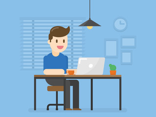 Young Man Working On The Computer  At His Working Place In Home Office.