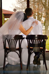 Newlywed couple admire the rain