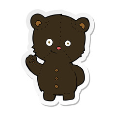sticker of a cartoon waving black bear cub